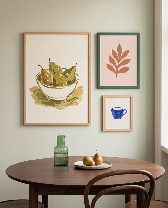 Framelane gallery wall of natural oak and forest green picture frames above a round walnut dining table