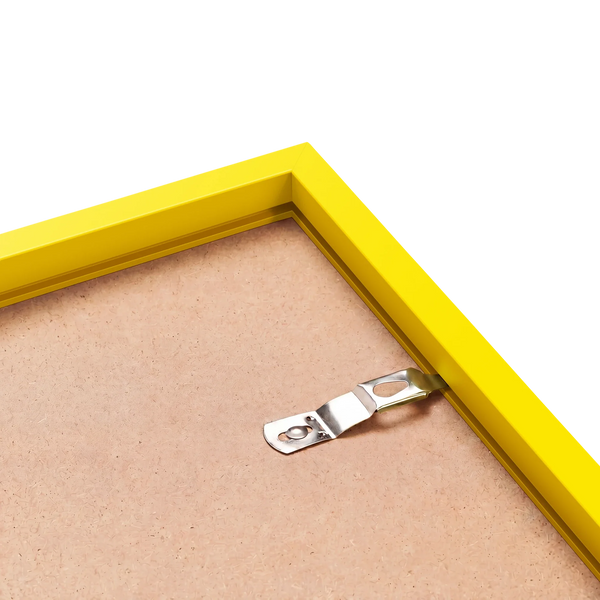 Back corner of a yellow wood picture frame with sawtooth hanger